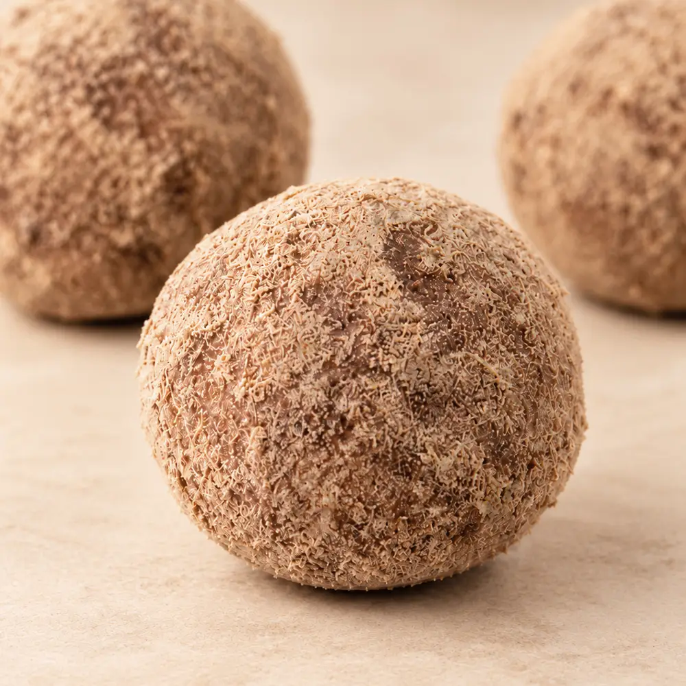 Close-up of a Carb Theory protein ball with its cocoa protein coating