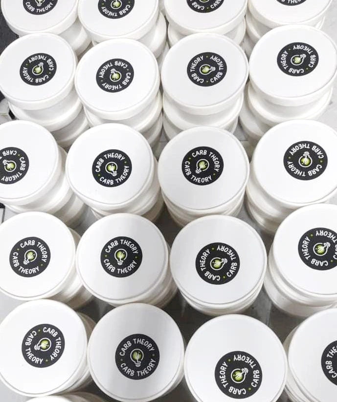 White takeaway food containers with Carb Theory branded lids