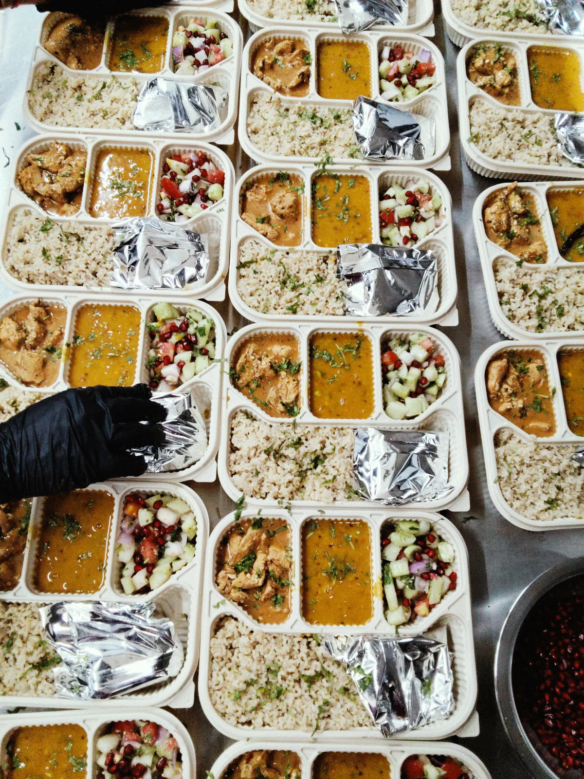 Freshly prepared corporate meal boxes with brown rice, curry, and salad at Carb Theory in Bangalore